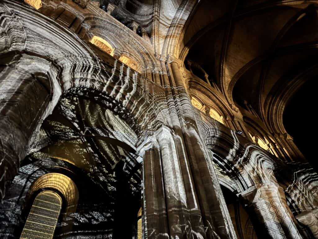 View of columns of Durham Cathedral during Everyone Ever Waterfall scene