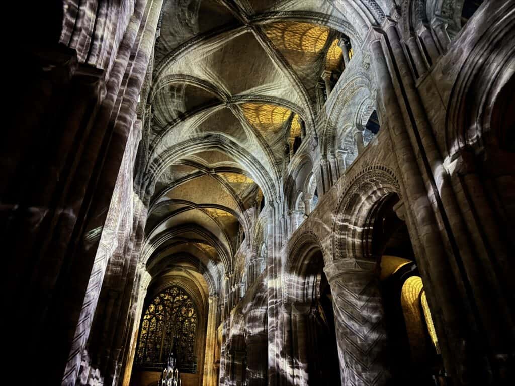 View of ceiling vaults of Durham Cathedral during Everyone Ever Waterfall scene